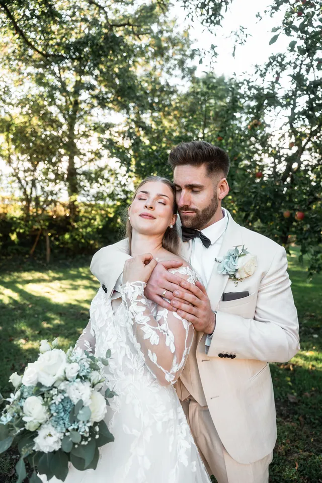 Braut lacht im Arm des Bräutigams, Hochzeit in der Schleifenmühle Dettenheim-Rußheim