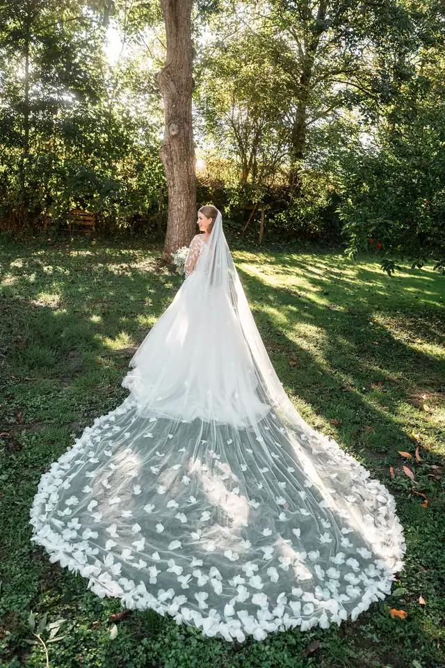 Braut mit langer Schleppe im Garten, Hochzeit in der Schleifenmühle Dettenheim-Rußheim