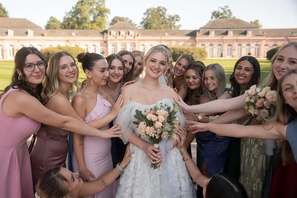 Freundinnen strecken die Hände zur Braut, Hochzeit am Schloss Schwetzingen